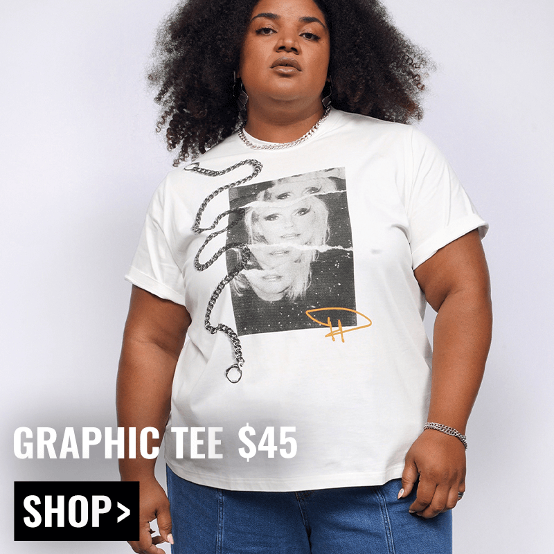 Model with curly black hair looks at camera wearing jeans and The Debbie Harry x Wildfang Graphic Tee. Text overlay reads GRAPHIC TEE $45 and button underneath reads SHOP.