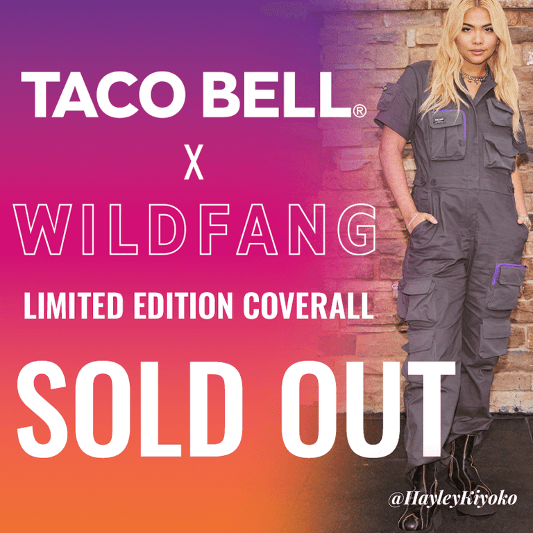 Purple, pink, and orange ombre background with image of Hayley Kiyoko on the right standing and looking at camera wearing the Taco Bell x Wildfang Coverall. Text overlay says TACO BELL X WILDFANG Limited Edition Coverall SOLD OUT. Hayley Kiyoko's instagram handle in the corner reads @HayleyKiyoko.