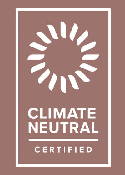 White Climate Neutral Certified logo on rose brown background